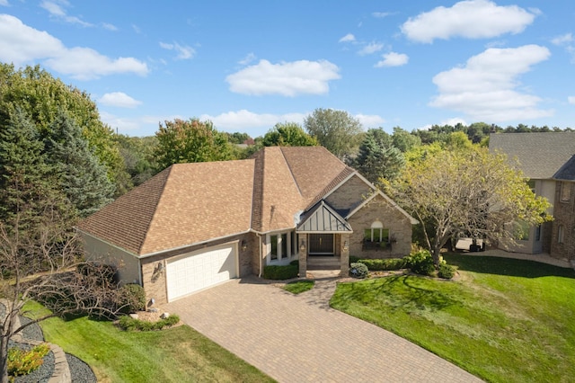 view of front of home featuring a garage and a front lawn