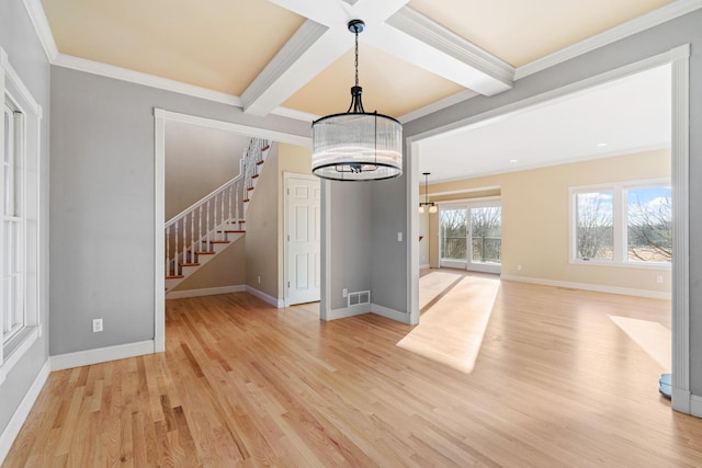 interior space with light hardwood / wood-style flooring, an inviting chandelier, beam ceiling, coffered ceiling, and ornamental molding