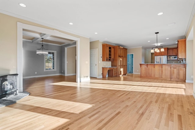 unfurnished living room with light wood-type flooring, ornamental molding, coffered ceiling, a notable chandelier, and beam ceiling