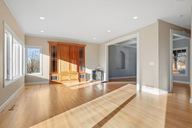 unfurnished living room featuring ornamental molding and light hardwood / wood-style floors