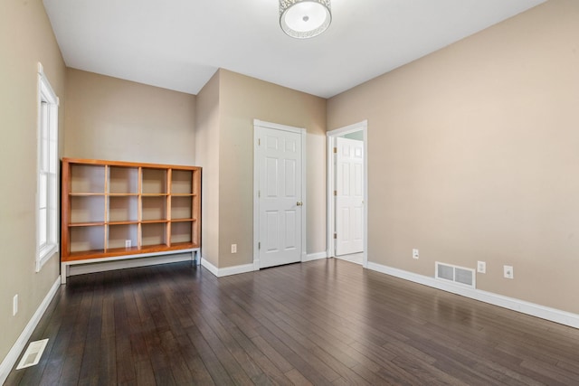 spare room with dark hardwood / wood-style flooring