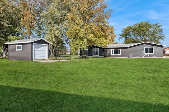 view of yard featuring a garage and an outdoor structure