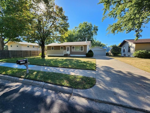 single story home with a garage, an outdoor structure, and a front yard