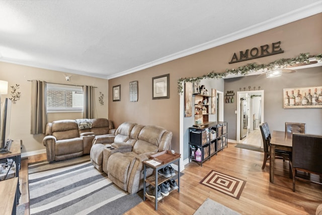 living room with wood-type flooring and ornamental molding