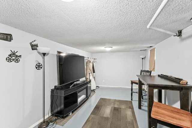 living room with wood-type flooring and a textured ceiling