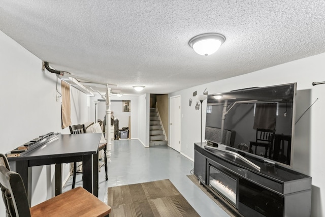 interior space with baseboards, stairway, and a textured ceiling