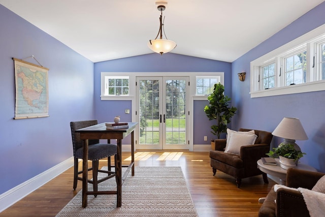 dining area with french doors, lofted ceiling, wood finished floors, and baseboards