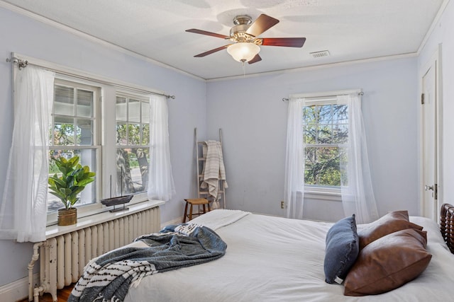 bedroom featuring radiator heating unit, ornamental molding, and ceiling fan