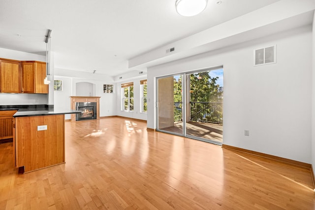 kitchen with a breakfast bar, light hardwood / wood-style flooring, and kitchen peninsula