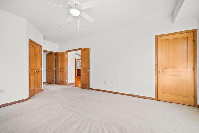 unfurnished bedroom with light carpet and ceiling fan