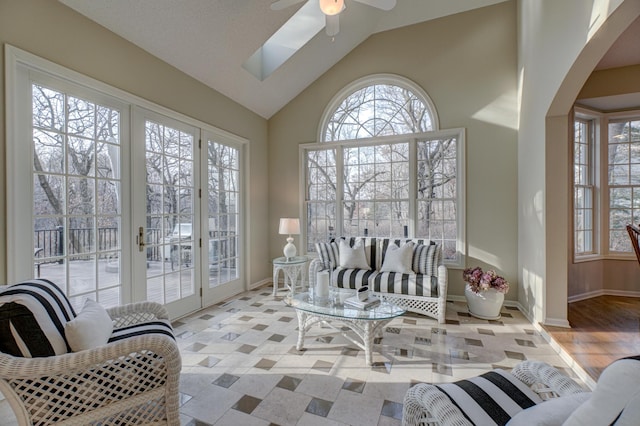 sunroom / solarium featuring lofted ceiling and ceiling fan