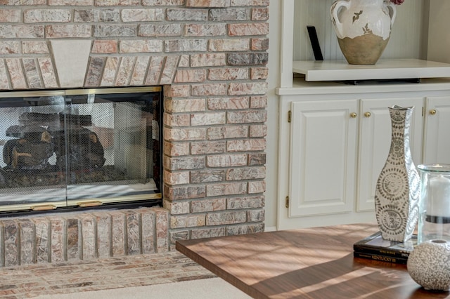 room details featuring a brick fireplace