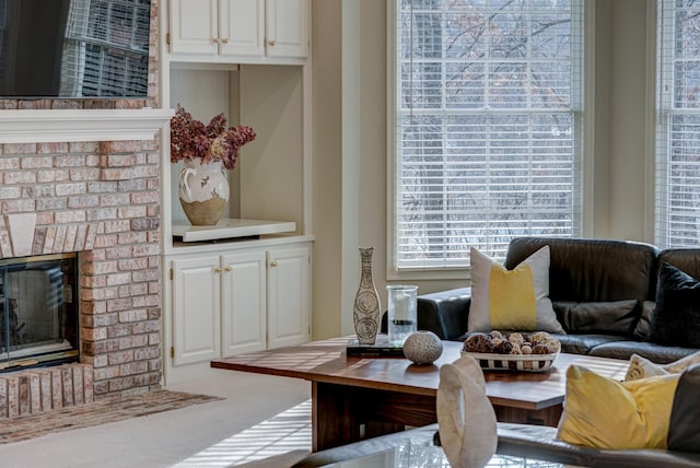 carpeted living room featuring a fireplace