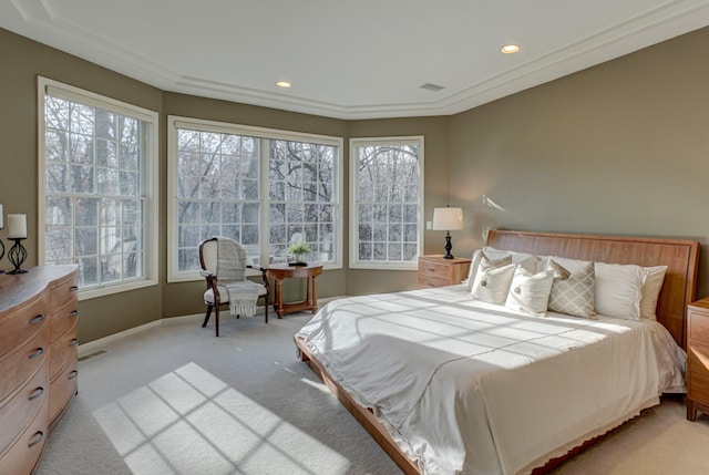 bedroom featuring multiple windows and light carpet