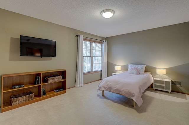 carpeted bedroom with a textured ceiling