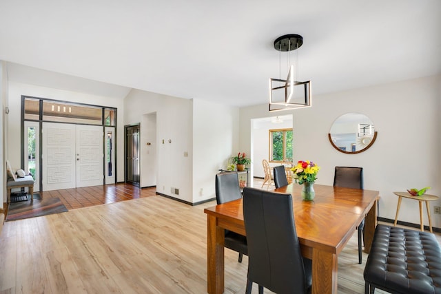 dining area featuring a wealth of natural light, a chandelier, and light hardwood / wood-style floors