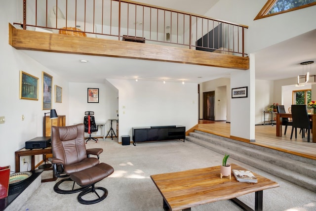 living room with light hardwood / wood-style floors and a high ceiling