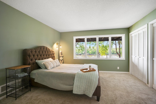 bedroom featuring a textured ceiling, a closet, and carpet flooring