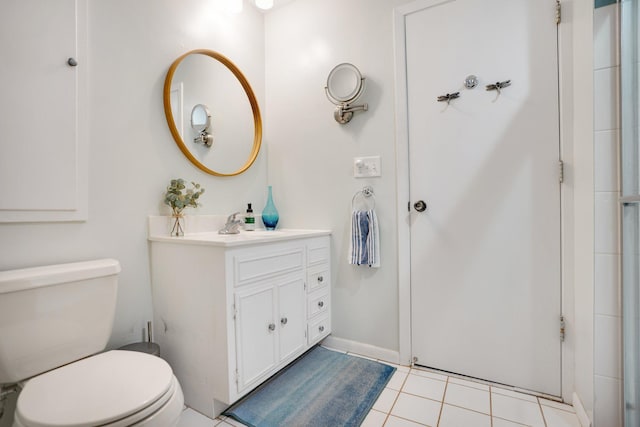 bathroom featuring tile patterned floors, vanity, and toilet