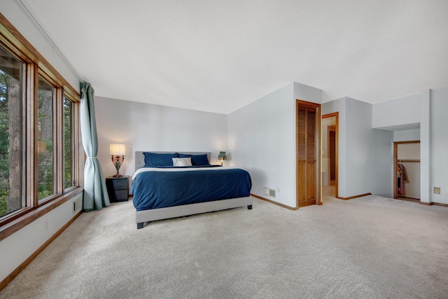 bedroom featuring light carpet and a closet