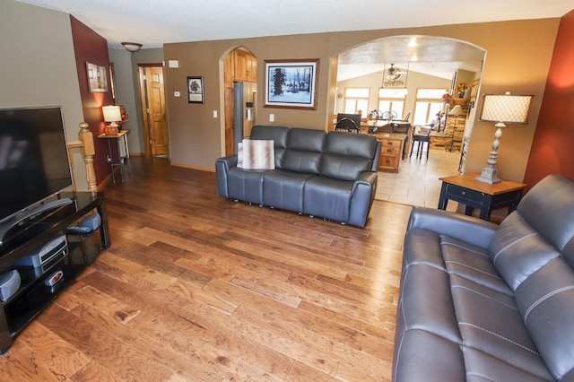 living room with hardwood / wood-style flooring and lofted ceiling