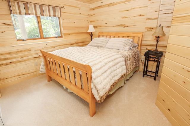 carpeted bedroom featuring wood walls