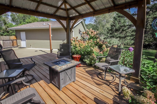 deck with an outdoor fire pit and a gazebo