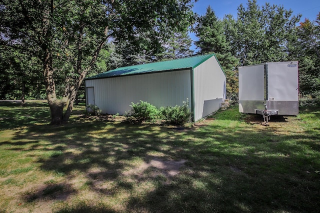 view of outdoor structure featuring a lawn