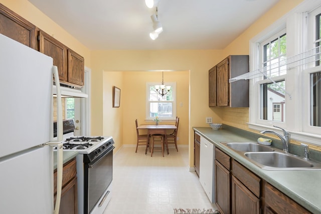 5025 16th Ave S, Minneapolis, MN 55417 - kitchen with white appliances, under cabinet range hood, a sink, and healthy amount of natural light