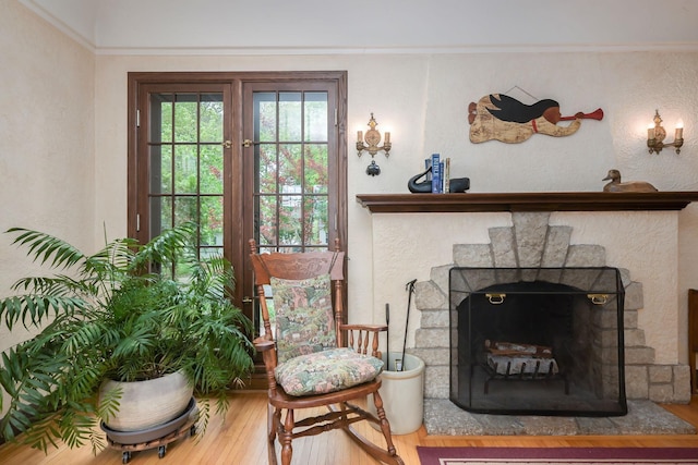 5025 16th Ave S, Minneapolis, MN 55417 - sitting room featuring wood finished floors, a textured wall, and a fireplace with raised hearth