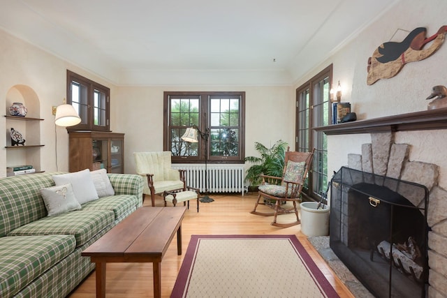 5025 16th Ave S, Minneapolis, MN 55417 - living room featuring radiator heating unit, wood finished floors, and ornamental molding