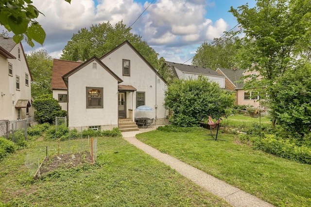 5025 16th Ave S, Minneapolis, MN 55417 - view of front of home with stucco siding, entry steps, and a garden