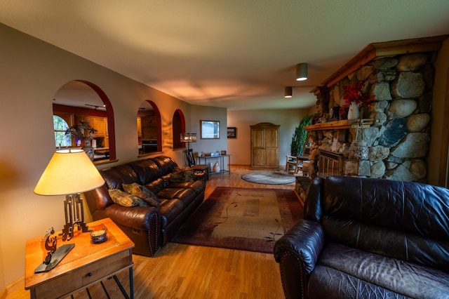 living room with light wood-type flooring and a fireplace