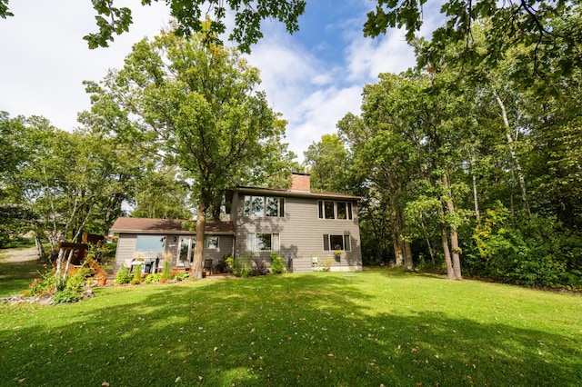 rear view of house with a yard