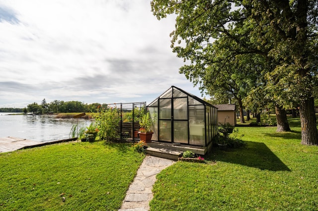 view of yard with a water view and an outdoor structure