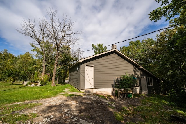 view of outbuilding with a lawn