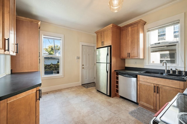 kitchen with appliances with stainless steel finishes, sink, and ornamental molding