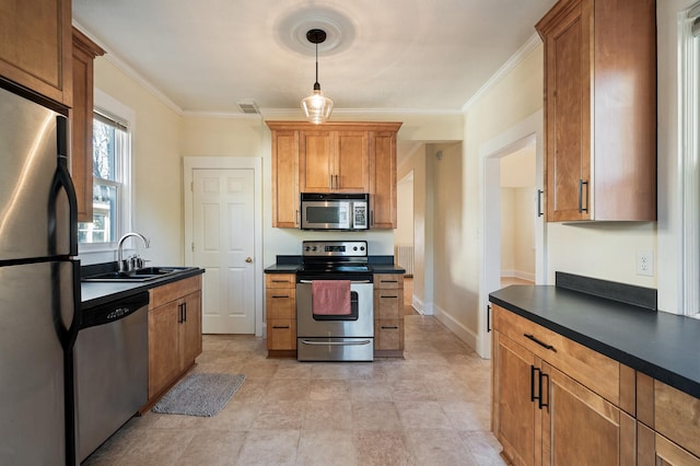 kitchen with ornamental molding, stainless steel appliances, sink, and decorative light fixtures