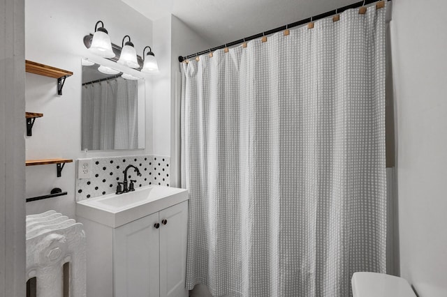 bathroom featuring vanity, toilet, tasteful backsplash, and a shower with curtain