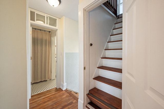 staircase featuring wood-type flooring