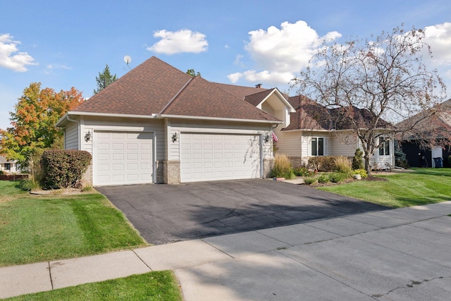 view of front of home with a garage and a front lawn