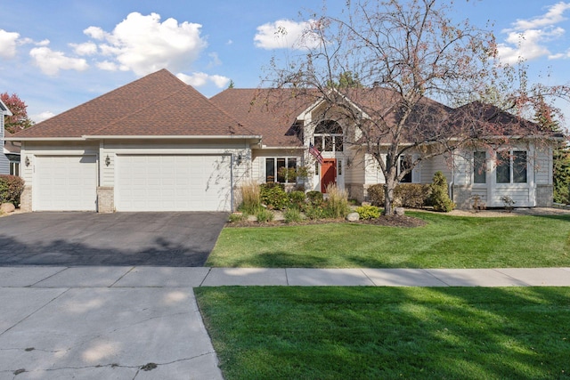 view of front of home with a front lawn and a garage