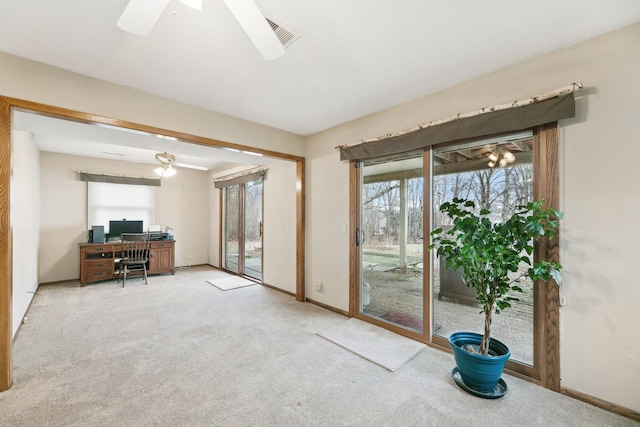 unfurnished office featuring light colored carpet and ceiling fan