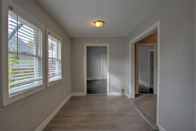 corridor with wood-type flooring