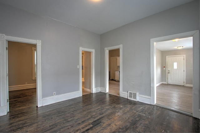 unfurnished room with dark hardwood / wood-style floors