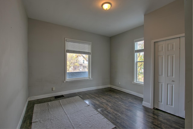 empty room featuring dark wood-type flooring