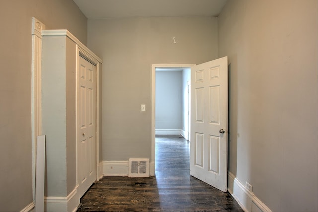 corridor with dark hardwood / wood-style flooring