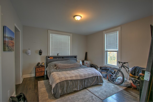 bedroom with dark wood-type flooring