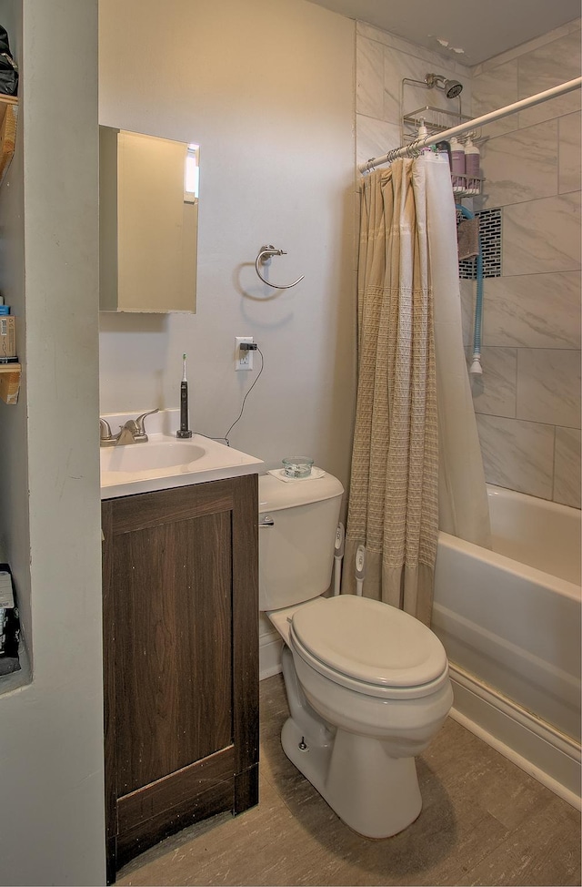 full bathroom with hardwood / wood-style flooring, vanity, toilet, and shower / bath combo with shower curtain