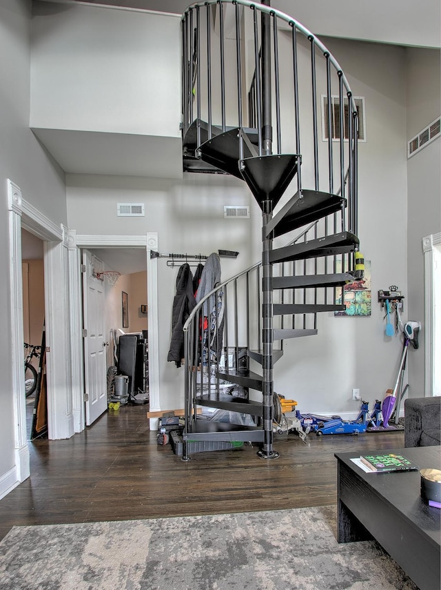 interior space featuring wood-type flooring and a high ceiling